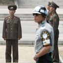 A South Korean soldier stands in front of North Korean troops at Panmunjom in the demilitarised zone separating the two countries