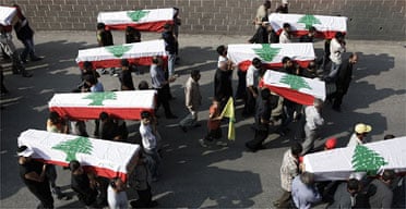 Mourners in Qana carry coffins draped in Lebanese flags. Photograph: Sean Smith/Guardian