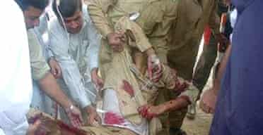 Paramedics tend to an injured Pakistani soldier after a suicide attack which in Dargai
