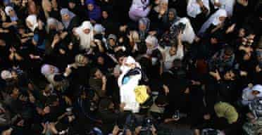 Palestinian mourners carry the body of three-year-old Maysa al-Athamna in Beit Hanoun