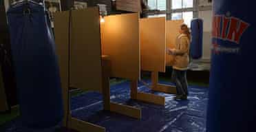 A woman walks over to a polling booth in a boxing school in Amsterdam, to vote in the Dutch parliamentary elections.