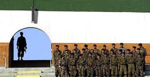 Iranian soldiers stand guard at the Azadi stadium in Tehran during a qualifying round for the 2006 World Cup