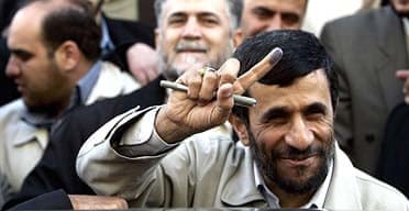 Mahmoud Ahmadinejad shows his ink-marked finger after casting his ballot