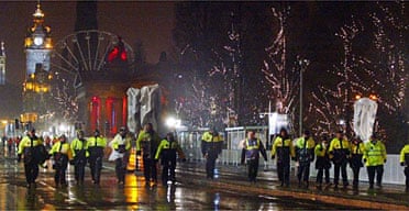 Security personnel clear Princes Street in Edinburgh last night after bad weather forced the cancellation of Hogmanay celebrations