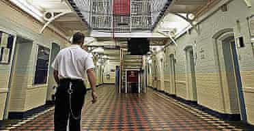 A prison officer walks through a wing of Norwich prison.