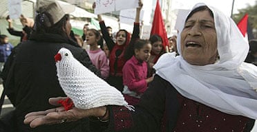 A woman holds a knitted dove in a protest calling for an end to the internal fighting between Hamas and Fatah in Gaza City.