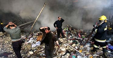 Iraqis grieve amid the rubble after a double car bomb attack in central Baghdad