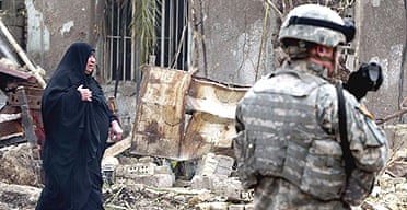 An Iraqi woman and a US soldier at the scene of the explosion in western Baghdad