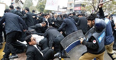 Pakistani police officers hit lawyers with batons during a rally to protest the sacking of the country's top judge