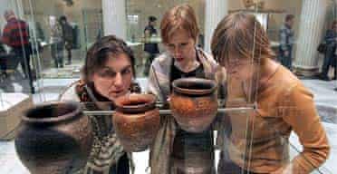 Visitors to the Pushkin museum examine the exhbition, which includes pottery, necklaces, and brooches with runic inscriptions