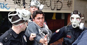 Turkish riot police detain a Kurdish demonstrator during Noruz celebrations to mark the coming of spring in Istanbul