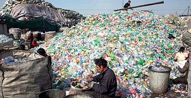 Migrant workers sort waste for recycling in China