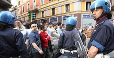 Italian riot police patrol Milan's Chinatown following clashes with local residents over a parking ticket