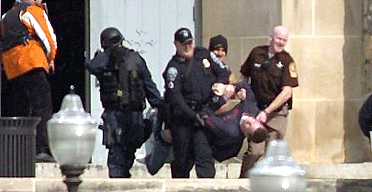 An injured occupant is carried out of Norris Hall at Virginia Tech in Blacksburg, Virginia