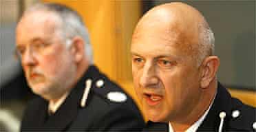 Kent police assistant chief constable Adrian Leppard (r) addresses the media after animal rights activism raids