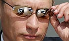 Vladimir Putin adjusts his sunglasses