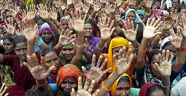Supporters of the Bahujan Samaj party raise their hands to express support at an election rally in Allahabad, India.