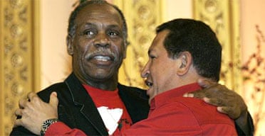 The Venezuelan president, Hugo Chavez (right), and actor Danny Glover embrace