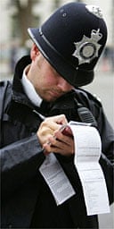 A police officer fills in a stop and search form 