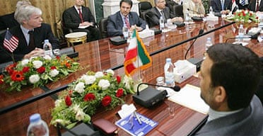 The US ambassador to Iraq, Ryan Crocker, faces his Iranian counterpart, Hassan Kazemi Qomi, across the negotiating table.
