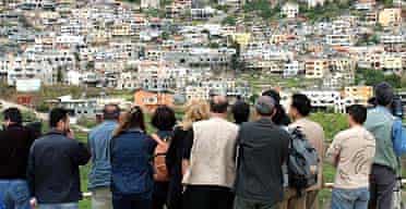 Syrians gaze across the shouting hill at the Israeli-occupied side of the Golan Heights
