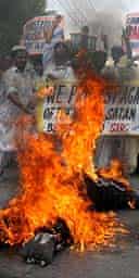 Religious students in Multan, Pakistan, burn effigies of the Queen and Salman Rushdie during protests against the awarding of the knighthood