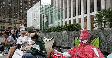 People wait in line outside Apple's flagship store on Fifth Avenue, New York, to be among the first to buy the iPhone. 