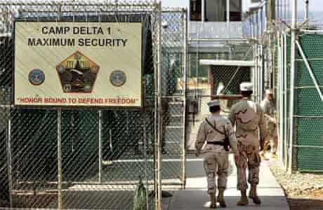 U.S. military guards walk within Camp Delta military-run prison, at the Guantanamo Bay U.S. Naval Base, Cuba