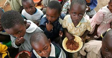 Primary school pupils in Bikita, eastern Zimbabwe, queue for their daily ration of beans and cereal