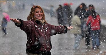 A woman enjoys the first major snowfall in nearly 90 years in Buenos Aires, Argentina