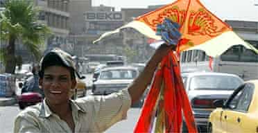 An Iraqi youth sells kites