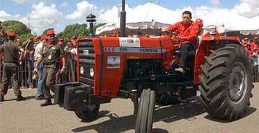 Venezuela's president Hugo Chavez rides a tractor made in Venezuela through a joint venture with Iran in Ciudad Bolivar, Venezuela