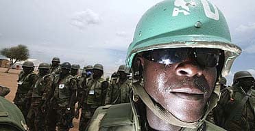 African Union soldiers stand guard at the Kor Abeche mission site, in southern Darfur.