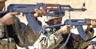 Iraqi soldiers train by shooting AK47 machine guns at a US marine base, near Baghdad.