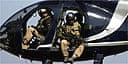 Members of Blackwater scan Baghdad from their helicopter