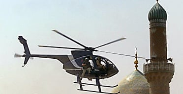 A Blackwater helicopter flying low in Baghdad