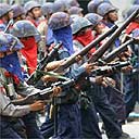 Armed Burmese security forces march down the streets of Rangoon to quell protests
