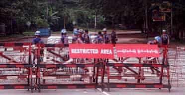 Myanmarese policemen at the checkpoint leading to the house of opposition leader Aung Sang Suu Kyi in Yangon, Burma.