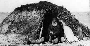 A photograph in Dr Memmot's book shows an Aboriginal man sitting in the doorway of a dome-shaped building