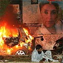 A wounded Pakistani man in front of Benazir Bhutto's truck after a suicide bomb attack in Karachi