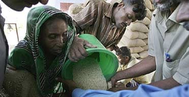 A woman receives rice in the Bangladeshi village of Purba Saralia