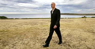 Former Midnight Oil frontman Peter Garrett walks along the headland at Sydney's Maroubra Beach