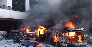 Cars burn at the scene of the bomb attack that killed Francois Hajj