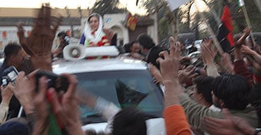 Benazir Bhutto waves from her car just seconds before being assassinated in a bomb attack following a political rally in Rawalpindi, Pakistan.