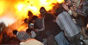 A bomb explodes next to the vehicle of Benazir Bhutto