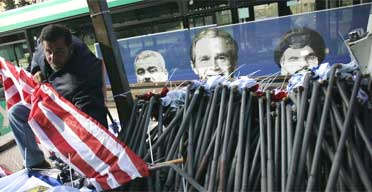 A Jerusalem municipal worker hangs a US flag