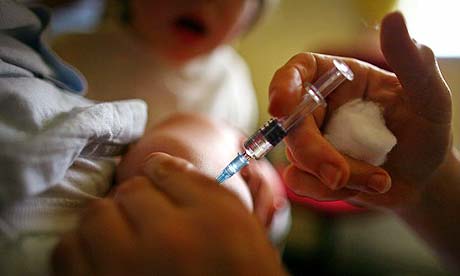 A young boy receives an immunisation jab at a health centre in Glasgow