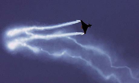 The BAE Eurofighter Typhoon military jet plane leaves smoke trails at an air show in Paris