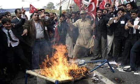Pakistani lawyers burn an effigy of the president, Pervez Musharraf, during a protest in Lahore