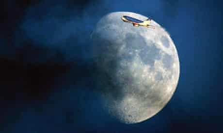 A bmi Airbus plane flying past the moon through a cloudy sky over London